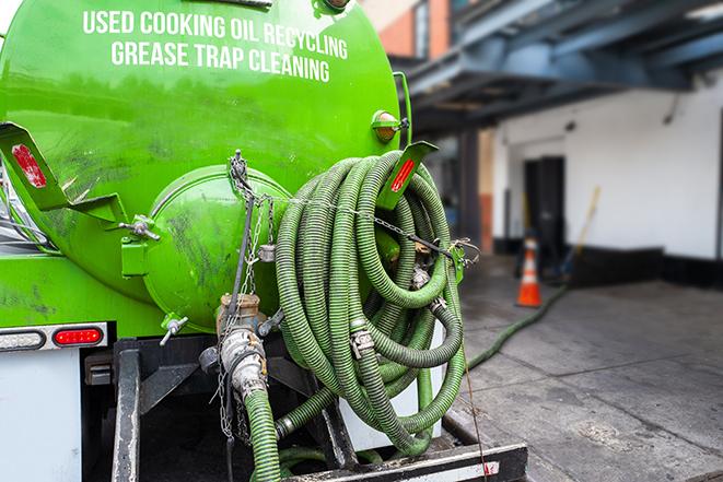 a professional technician pumping a restaurant's grease trap in El Lago TX